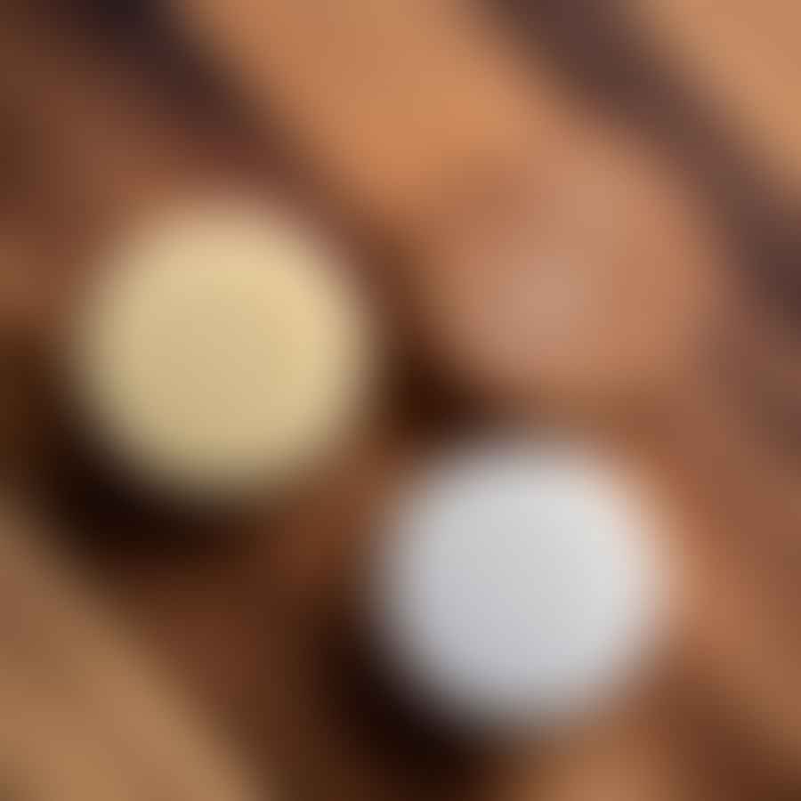 Solid shampoo and conditioner bars displayed on a wooden surface