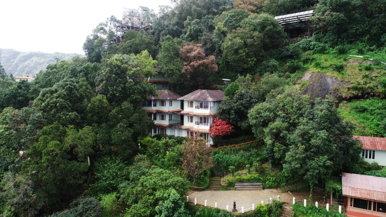 Serene view of the eco-friendly Blackberry Hills Retreat & Spa surrounded by lush greenery in Munnar